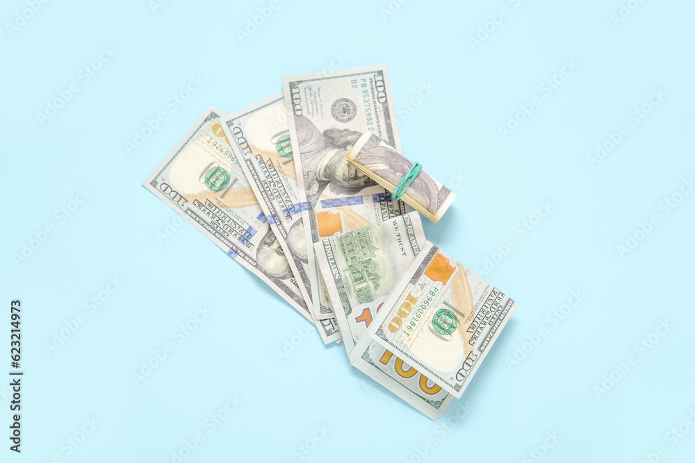 One hundred dollar banknotes on color background One hundred dollar banknotes on color background