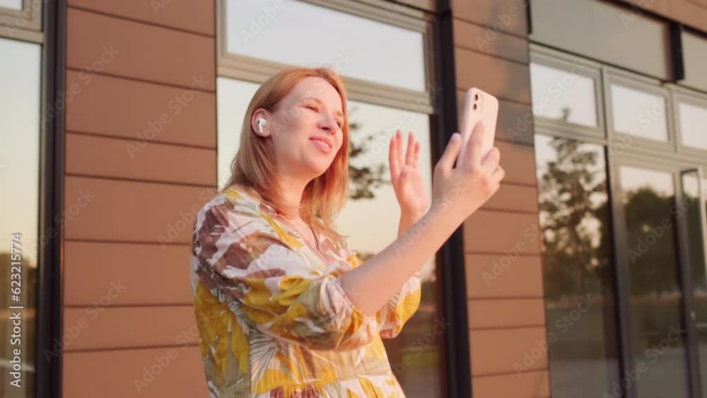 Smiling pregnant woman says hello and has a video call near the business center at the sunlight Smiling pregnant woman says hello and has a video call near the business center at the sunlight