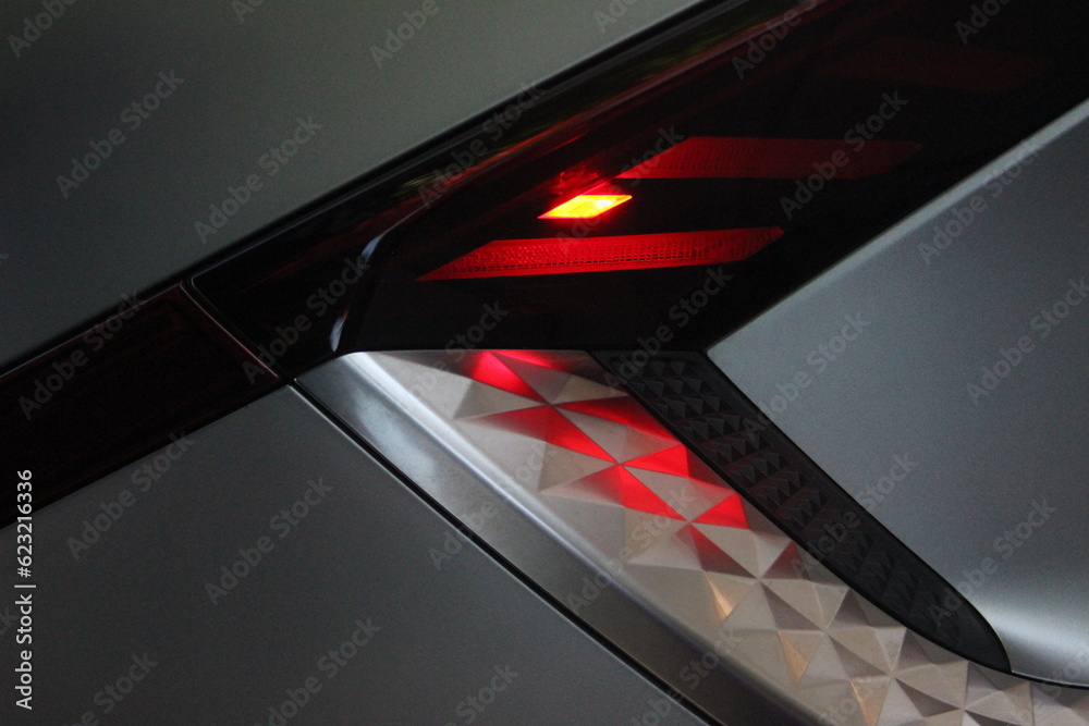 Red LED light on electric car closeup. Electric vehicle charging