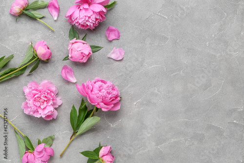 Composition with beautiful peony flowers on grunge background