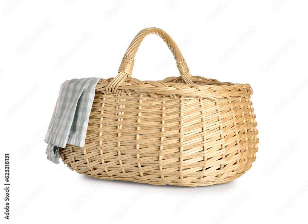 Wicker picnic basket with checkered napkin on white background