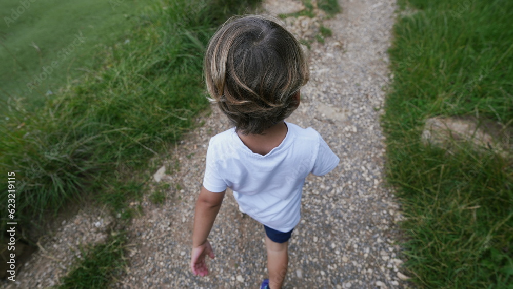 One small boy walking on path from above angle of kid One small boy walking on path from above angle of kid