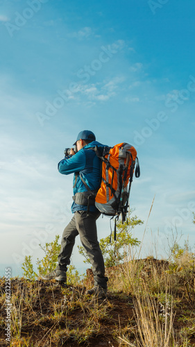 Hiker Traveler Immersed in Photography