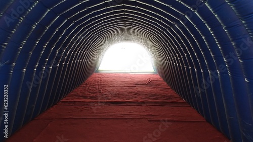 Obraz na płótnie interior view of inflatable tunnel to go out to sports stadium, light at the end