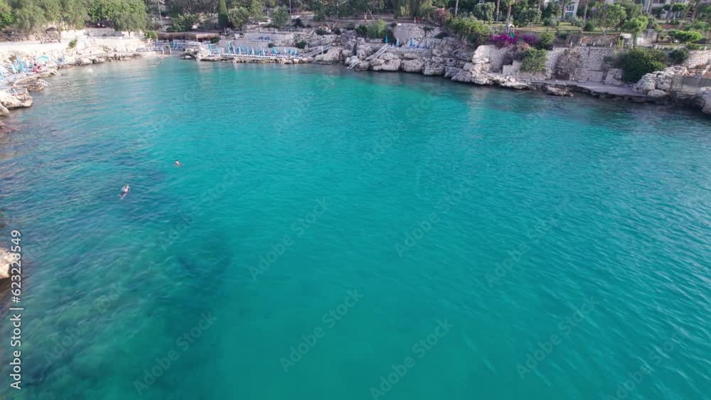 Aerial view of people bathing in sea in the morning. Aerial view of people swimming in blue crystal clear lagoon Aerial view of people bathing in sea in the morning. Aerial view of people swimming in blue crystal clear lagoon
