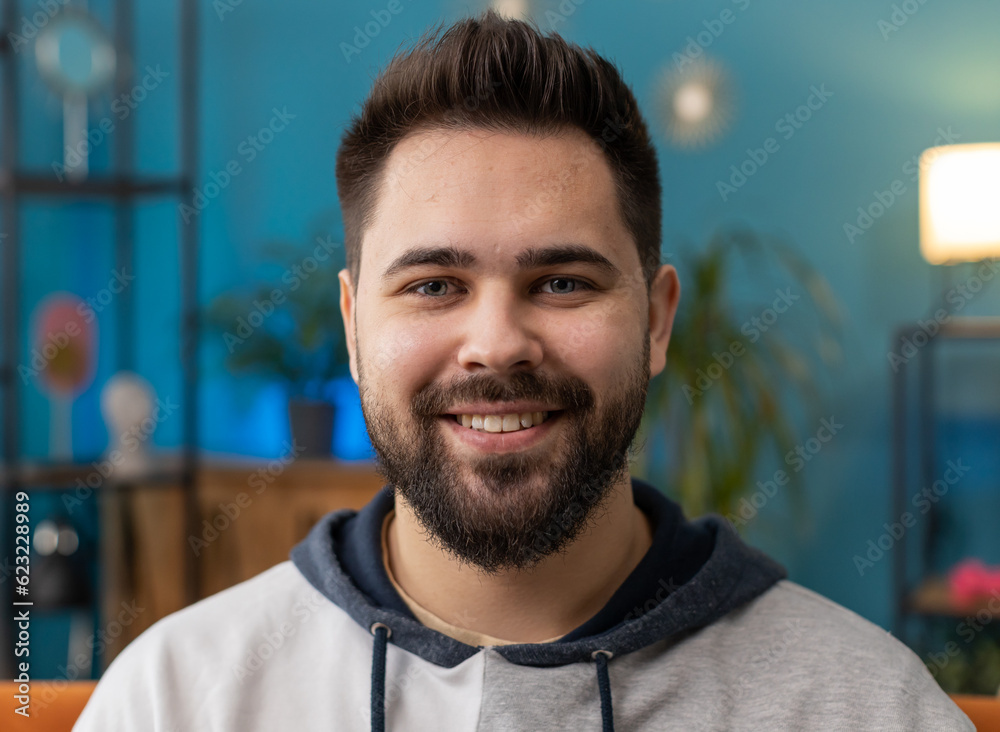 Portrait of happy calm Caucasian man at home couch smiling friendly, glad expression looking away dreaming resting, relaxation feel satisfied concept good news, celebrate win. Young guy in living room Portrait of happy calm Caucasian man at home couch smiling friendly, glad expression looking away dreaming resting, relaxation feel satisfied concept good news, celebrate win. Young guy in living room