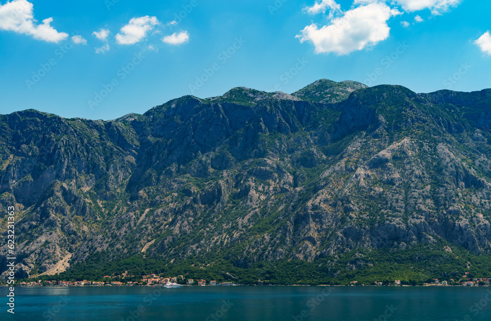 seascapes, a view of the Bay of Kotor during a cruise on a ship in Montenegro, a bright sunny day, mountains and coast, the concept of a summer trip