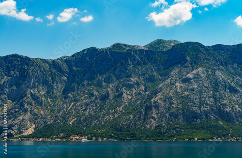 seascapes  a view of the Bay of Kotor during a cruise on a ship in Montenegro  a bright sunny day  mountains and coast  the concept of a summer trip