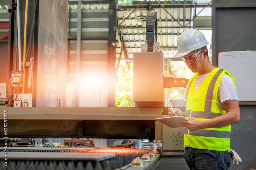 Ταπετσαρία A civil Engineer man holding tablet collecting intel of laser cutting machine wi