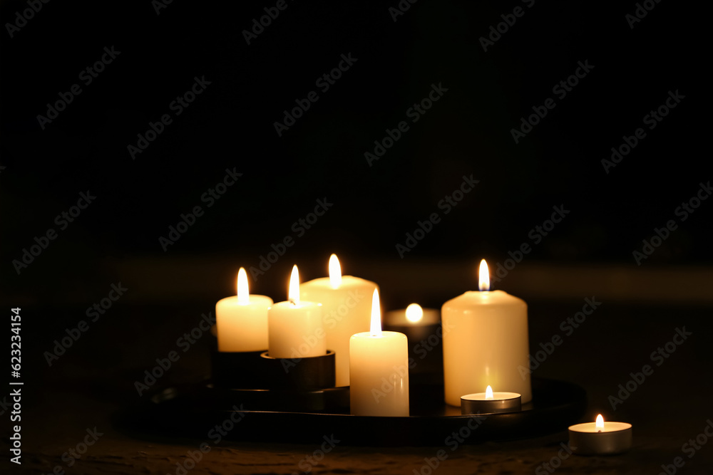 Burning candles on dark background Burning candles on dark background