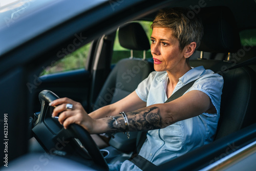 Stressed angry mature senior woman in driver's seat car frustration