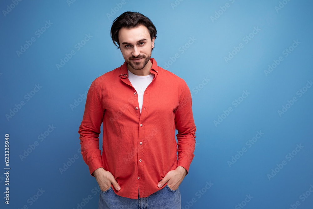 handsome brutal young brunette man in red shirt handsome brutal young brunette man in red shirt
