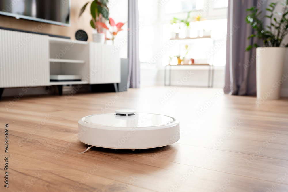White robot vaccum cleaner in the living room White robot vaccum cleaner in the living room