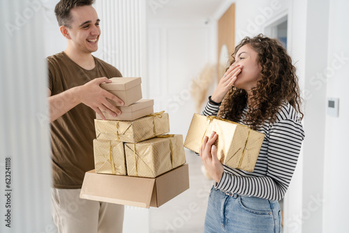 Canvastavla man and woman give gift box presents at home holiday surprise concept