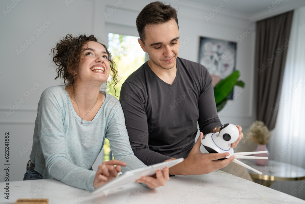 young couple man and woman starting home security surveillance camera young couple man and woman starting home security surveillance camera