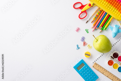 Discover the joy of education for young learners through this top view snapshot: an appealing array of colorful child stationery on a white background, ready for text or advert incorporation
