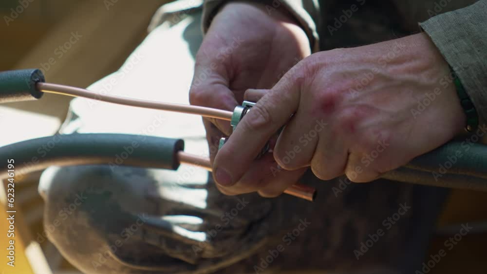 Cutting a copper pipe. The process of removing the desired piece of pipe. Cutting a copper pipe. The process of removing the desired piece of pipe.