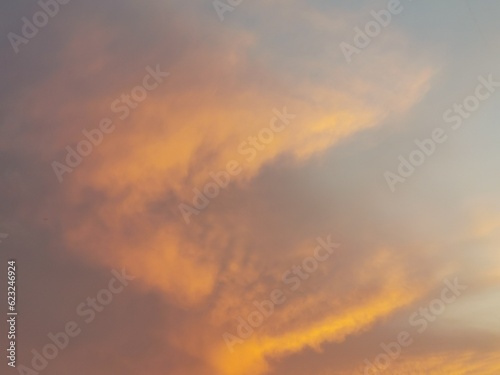 The sunset sky is decorated with clouds in various shapes, very beautiful. © Beatrix
