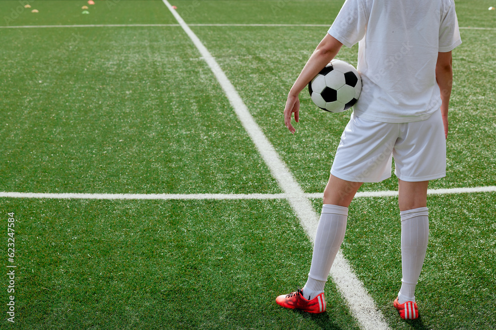 Obraz premium soccer ball in the center of the field at the start of the game