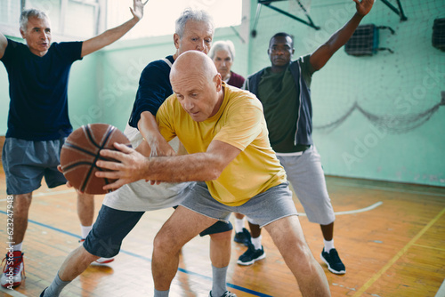 Seniors playing basketball in an indoor gym