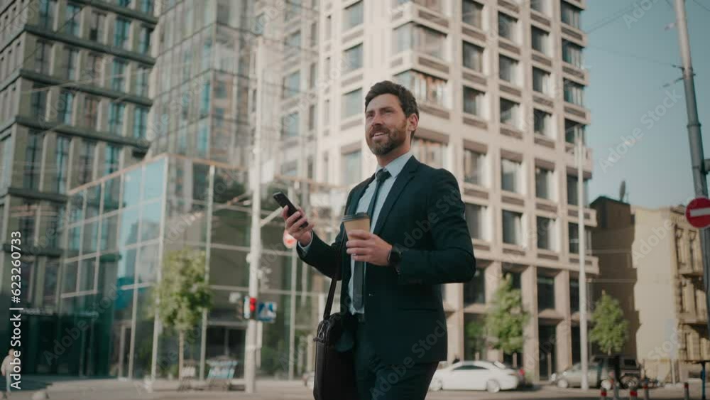 Smiling businessman goes to work chatting online on phone Smiling businessman goes to work chatting online on phone