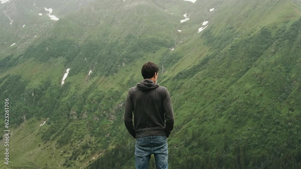 Happy travel man standing top of mountains Happy travel man standing top of mountains