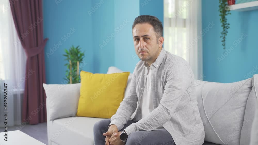 Man looking at camera with dull expression.