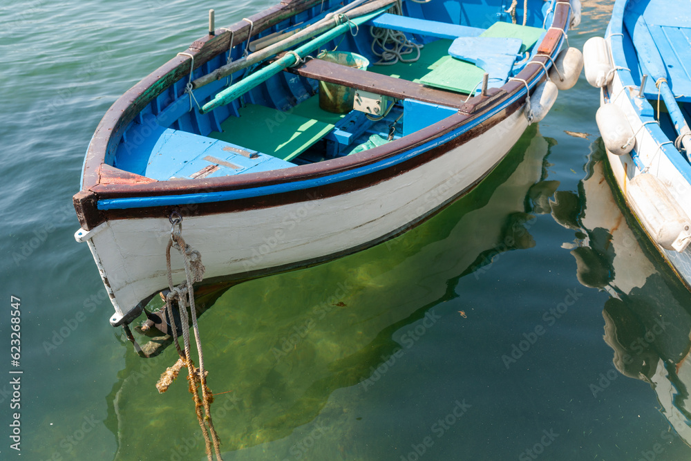 Traditional fishing dinghy moored with rope