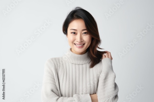 Portrait of a beautiful young asian woman smiling and looking at camera © Robert MEYNER