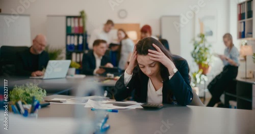 Worried businesswoman with documents in office.