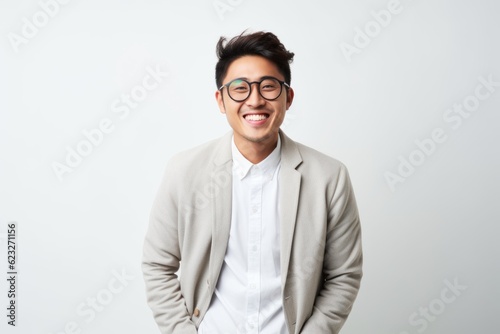 Portrait of a happy young asian man wearing eyeglasses © Robert MEYNER