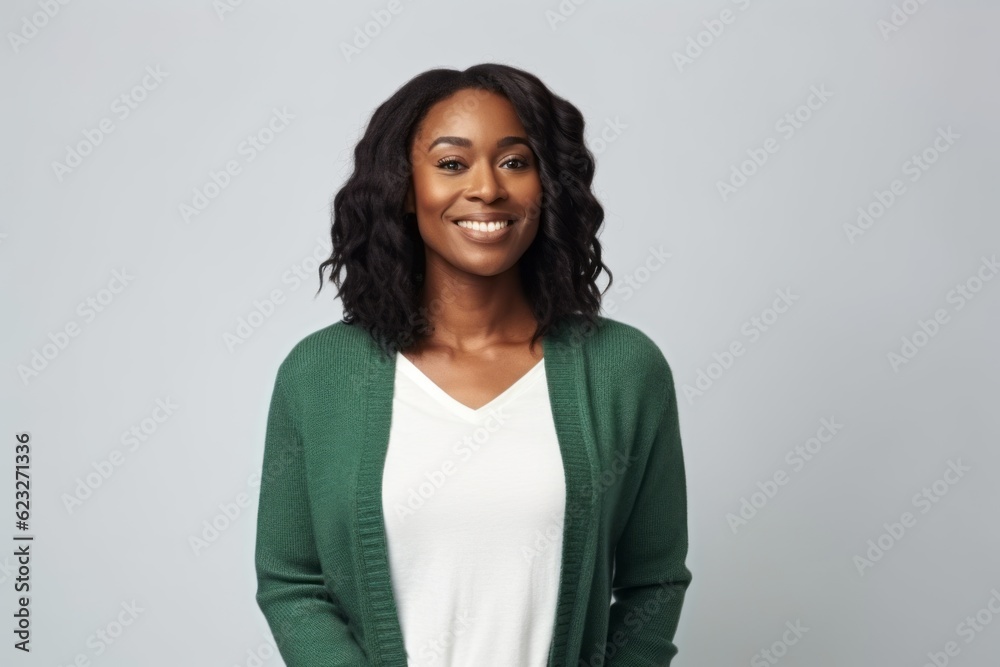 smiling african american woman in green sweater over grey background smiling african american woman in green sweater over grey background