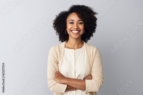 Medium shot portrait photography of a pleased Nigerian black woman in her 30s wearing a chic cardigan against a white background 