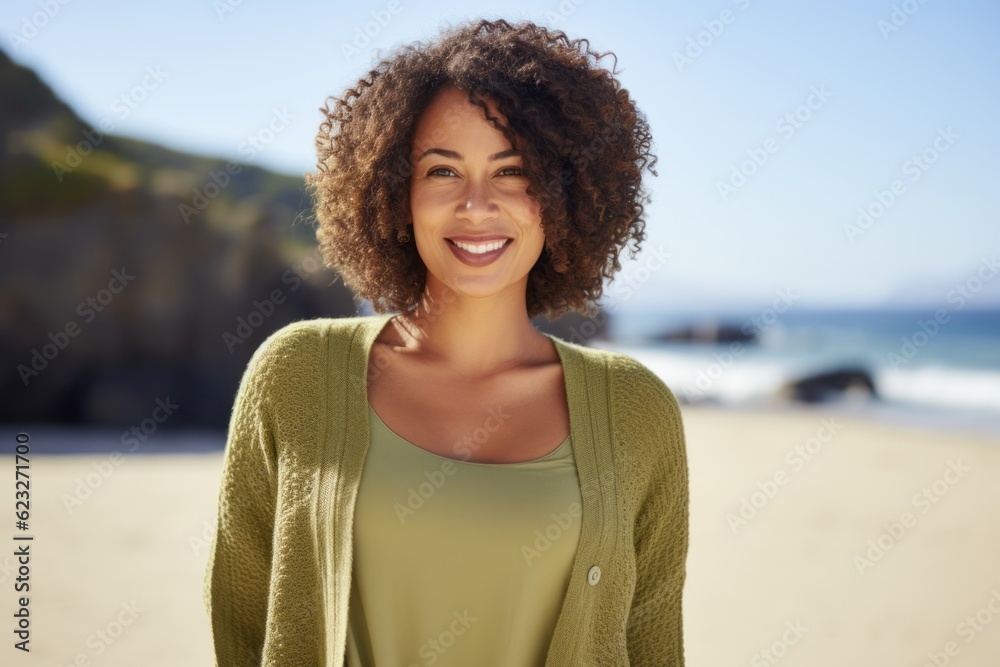 Portrait of a happy young woman smiling at camera on the beach Portrait of a happy young woman smiling at camera on the beach