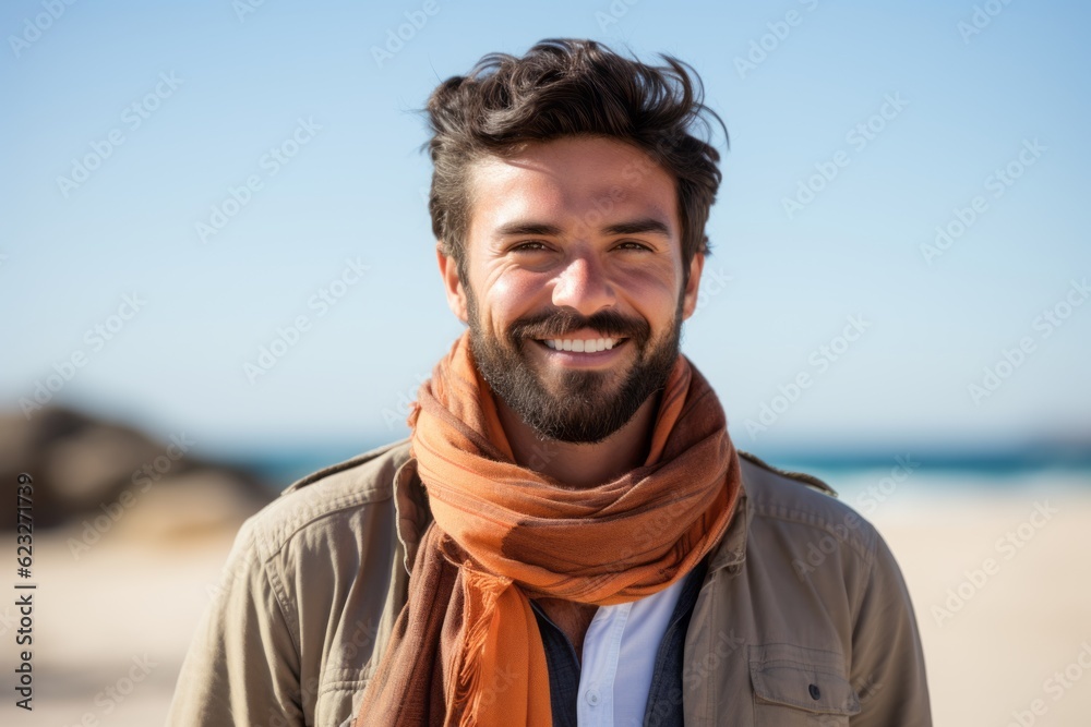 Portrait of a handsome young man smiling at the camera on the beach Portrait of a handsome young man smiling at the camera on the beach