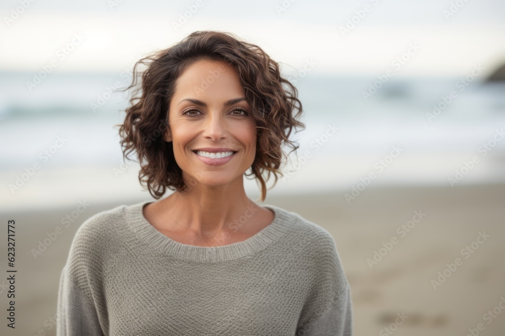 Portrait of smiling woman standing on beach at the day time with copy space Portrait of smiling woman standing on beach at the day time with copy space