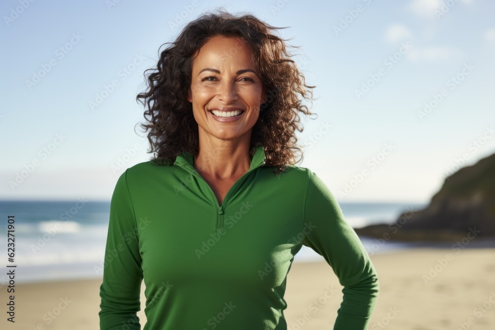 Portrait of smiling woman standing on beach with arms akimbo Portrait of smiling woman standing on beach with arms akimbo