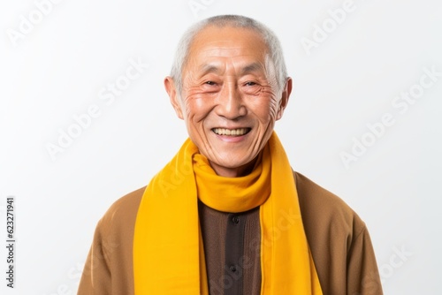 Portrait of happy senior asian man wearing yellow scarf on white background