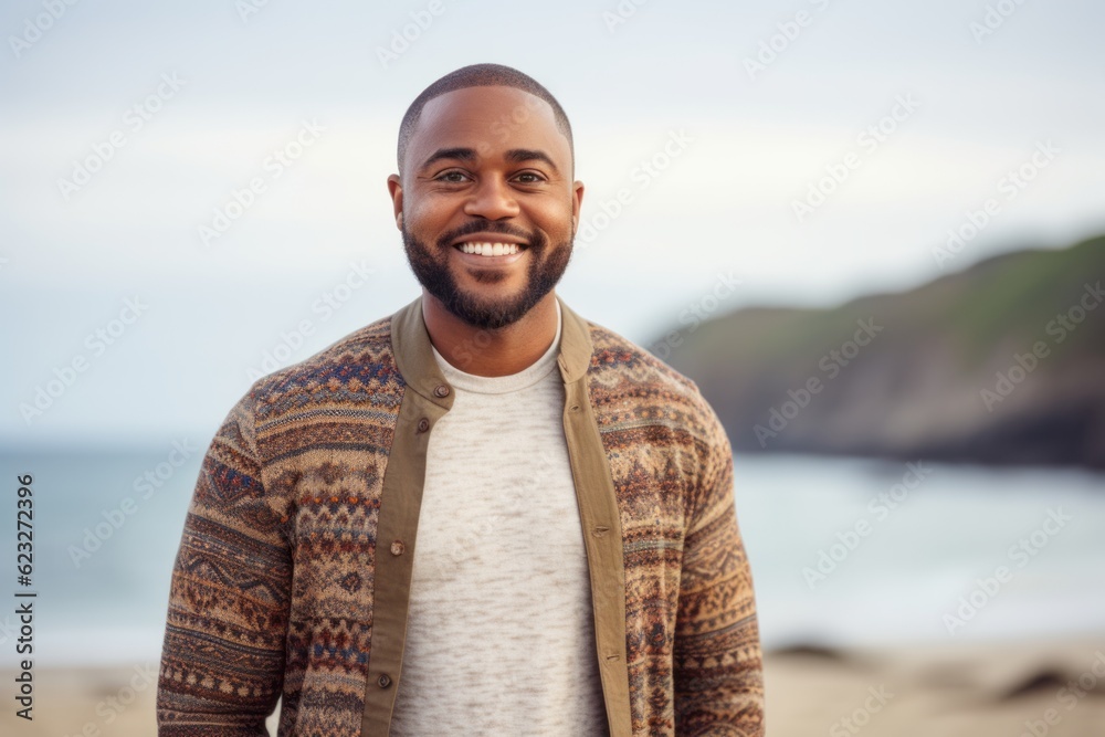 Portrait of a smiling young man standing on the beach at the day time Portrait of a smiling young man standing on the beach at the day time