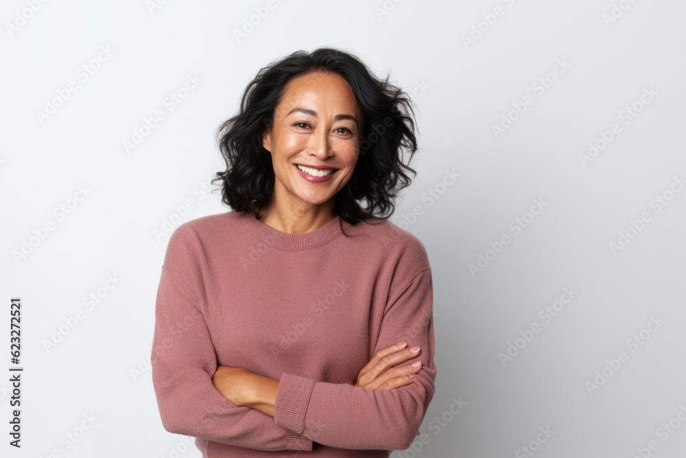 Portrait of a happy woman standing with arms crossed against white background Portrait of a happy woman standing with arms crossed against white background
