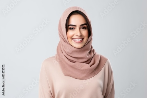 Portrait of a happy muslim woman in hijab looking at camera isolated on a white background