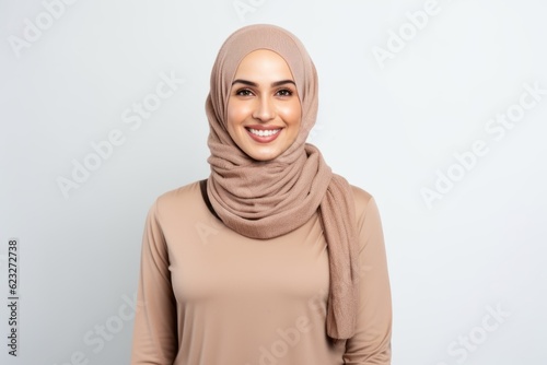 muslim woman in hijab smiling at camera isolated on white with copy space