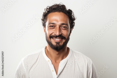 Portrait of a handsome young man smiling at camera isolated on a white background