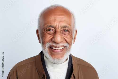 Portrait of a smiling senior man looking at camera on white background