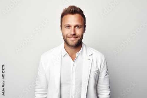 Portrait of a handsome young man in a white shirt on a white background