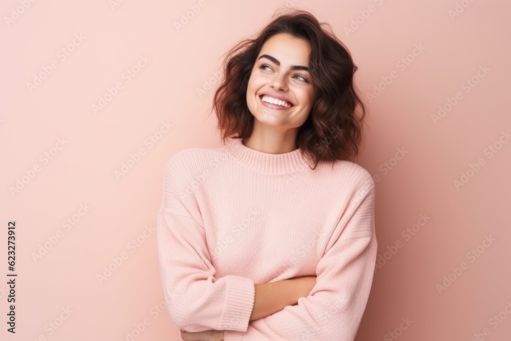 Portrait of a happy young woman standing with arms folded isolated over pink background Portrait of a happy young woman standing with arms folded isolated over pink background