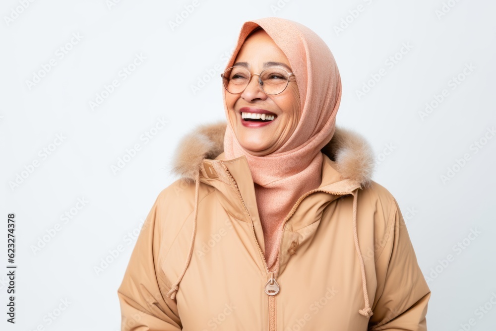 portrait of happy muslim woman in winter coat and eyeglasses portrait of happy muslim woman in winter coat and eyeglasses