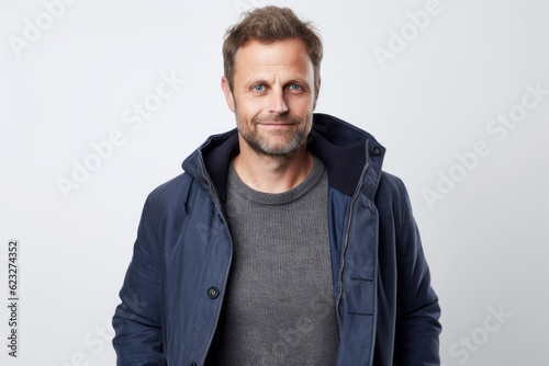 Portrait of a handsome man in a blue jacket on a white background
