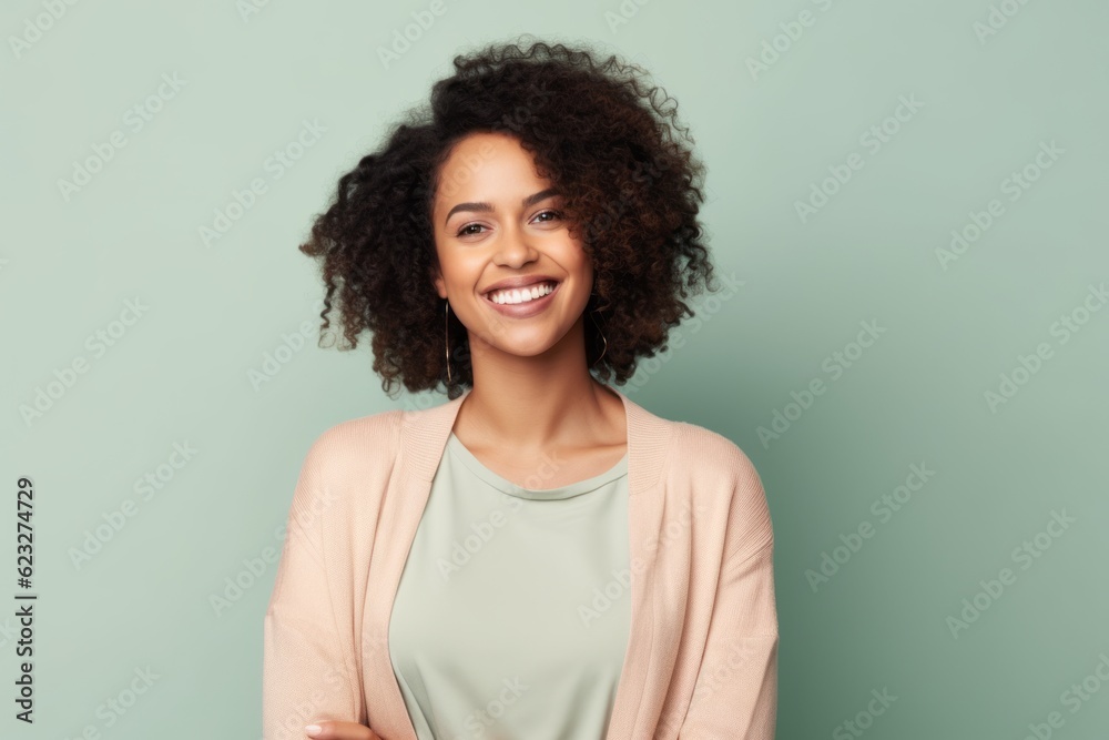 smiling african american woman in beige jacket on green background