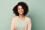 smiling african american woman in beige jacket on green background